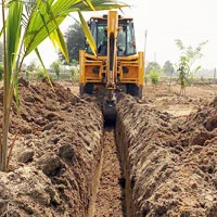 Underground electrical, buried conduit, trench being dug for electrical conduit.